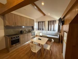 a kitchen with a table and chairs and a couch at Porta 4 City Flat in Vila Real