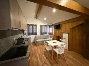 a kitchen and living room with a table and chairs at Porta 4 City Flat in Vila Real +3 photos