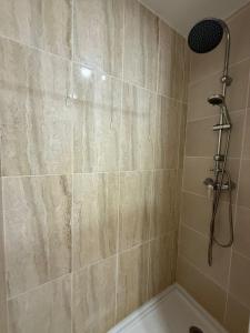 a bathroom with a shower with a stone wall at Porta 4 City Flat in Vila Real