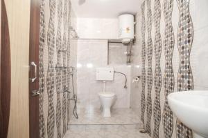 a bathroom with a toilet and a sink at Hotel Red Rose in Darjeeling