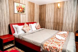a bedroom with a large bed in a room at Hotel Red Rose in Darjeeling