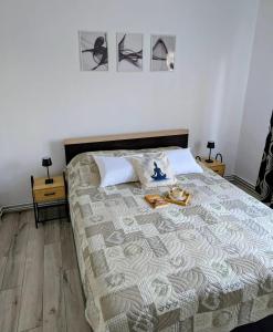 a bedroom with a bed with shoes on it at Ariana Urban Loft in Târgu-Mureş
