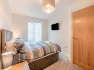 a bedroom with a bed and a window at Martin - Uk48161 in Filey