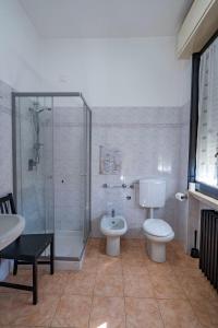 a bathroom with a shower and a toilet and a sink at Locanda San Martino in Collecchio