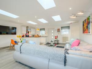 a living room with a couch and a kitchen at Craigpark Lodge in Caldercruix +16 photos