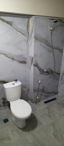 a bathroom with a toilet and a shower at Ayışık Otel in Hamidiye
