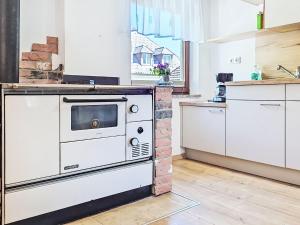 a kitchen with an oven in the middle of a room at Apartment Loidl by Interhome in Ebensee