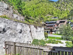 a fence in front of a mountain with houses at Apartment Loidl by Interhome in Ebensee
