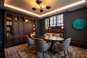 a dining room with a table and chairs at Corinthia Rome in Rome