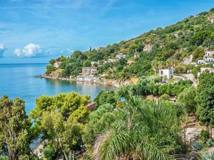 a view of a beach with trees and houses at Villaggio Club Tortorella in Marina di Casalvelino