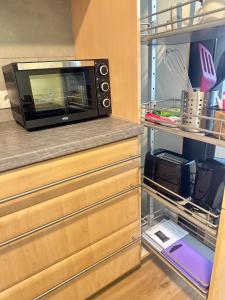 a microwave sitting on a counter in a kitchen at Smile Home in Klagenfurt