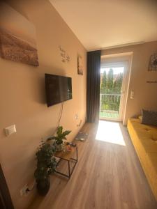 a living room with a couch and a window at Smile Home in Klagenfurt