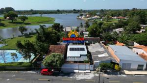 a sign for a restaurant with a river in the background at Casapalmares in Parintins