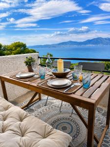 a wooden table with a candle on top of it at SeaTerra Boutique suite in Kalamos