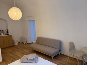 a living room with a couch and a table at room4you Lambach Apartment, Studiozimmer & Zimmer in Lambach