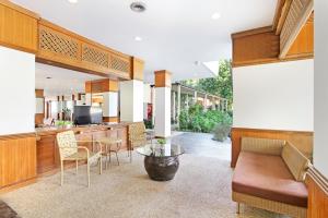 a kitchen and living room with a table and chairs at Rayong Chalet Hotel And Resort in Klaeng