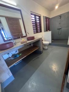 a bathroom with a sink and a toilet at Guest House Antsakoa in Nosy Komba +33 photos