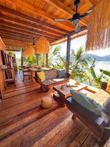 a living room with a couch and a table at Guest House Antsakoa in Nosy Komba