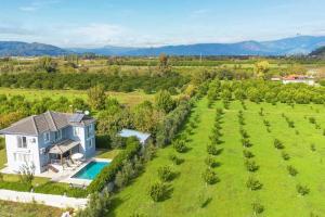an aerial view of a house in a field with a pool at Villas Dogakent in Ortaca