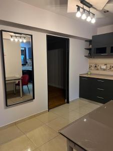 a kitchen with a large mirror and a table at GZP Residence Lugoj 6 in Lugoj
