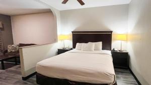 a hotel room with a bed and a chair at Studio 6 Suites Houston, TX - Spring in Houston +43 photos