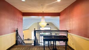 a staircase with a piano in a room at Studio 6 Suites Houston, TX - Spring in Houston