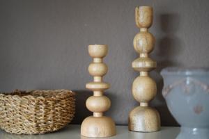 two wooden candlesticks sitting on top of a table at Happywild in Schlangenbad