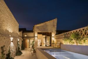 a villa with a swimming pool at night at Casa Felicita in Casas de Pradas