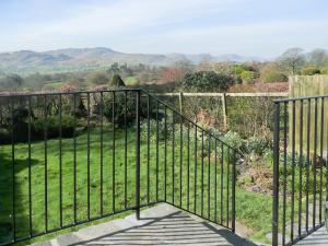 a wrought iron fence with a view of a garden at Cropple Howe in Threlkeld