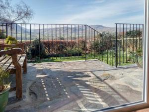 a gate to a patio with a view of the mountains at Cropple Howe in Threlkeld