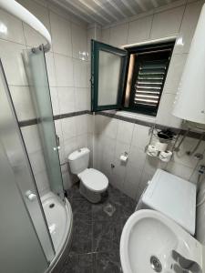 a bathroom with a toilet and a sink and a mirror at Promenade,5 min Old Town in Kotor +13 photos