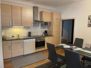 a kitchen with wooden cabinets and a table with chairs at Vermietung Ronner in Vordernberg