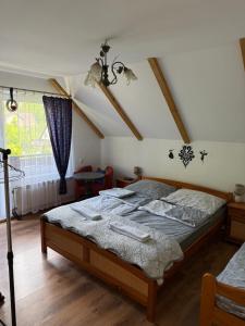 a bedroom with a large bed in a attic at Pokoje Przy Szlaku Agroturystyka in Żabnica