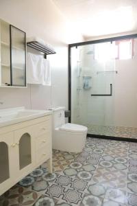a bathroom with a toilet and a sink and a shower at 巷子民宿 in Kashgar