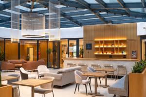 a lobby of a restaurant with tables and chairs at Visula Hotel & Spa - New Opening 2026 in Medulin