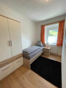 a small bedroom with a bed and a window at Vermietung Ronner in Vordernberg