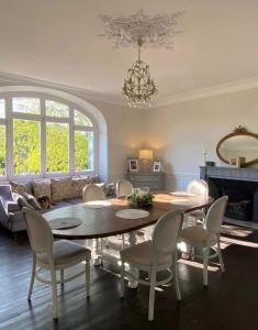 a living room with a table and chairs and a couch at Le clos joli in Saint-Saviol