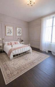 a bedroom with a white bed and a rug at Le clos joli in Saint-Saviol +9 photos