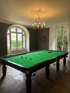 a billiard table in a room with at Le clos joli in Saint-Saviol