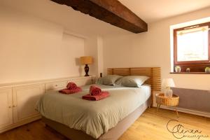 a bedroom with a bed with red slippers on it at Sous les toits de Sainte-Cécile in Albi