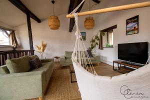 a living room with a couch and a hammock at Sous les toits de Sainte-Cécile in Albi