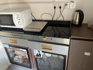 a microwave oven sitting on top of a kitchen counter at 巷子民宿 in Kashgar