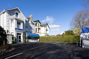 a parking lot in front of a white house at The Westgate in Torquay