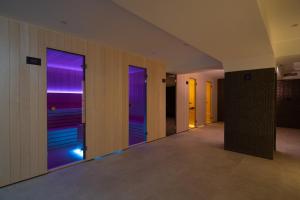 an empty hallway with purple windows in a building at Visula Hotel & Spa - New Opening 2026 in Medulin +53 photos