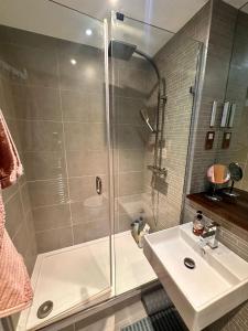 a bathroom with a shower and a sink at Bright and Modern Forest Hill Flat - Flexible Stay in Forest Hill