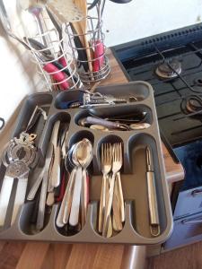 a tray filled with utensils on top of a stove at Sunrise Caravan in Dymchurch