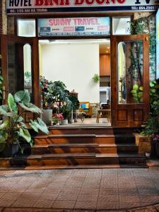 an entrance to a building with a lobby with plants at Sunny C Hotel in Hue