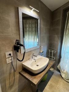 a bathroom with a sink and a mirror at GardaBreak Rooms&Breakfast Holiday Apartments in Riva del Garda +90 photos
