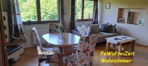 a living room with a table and chairs and a couch at FeWoFreiZeit in Rheinau