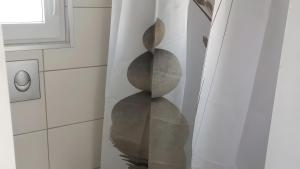 a staircase with a sculpture of rocks in a room at Glücks-Gezeiten in Wurster Nordseeküste